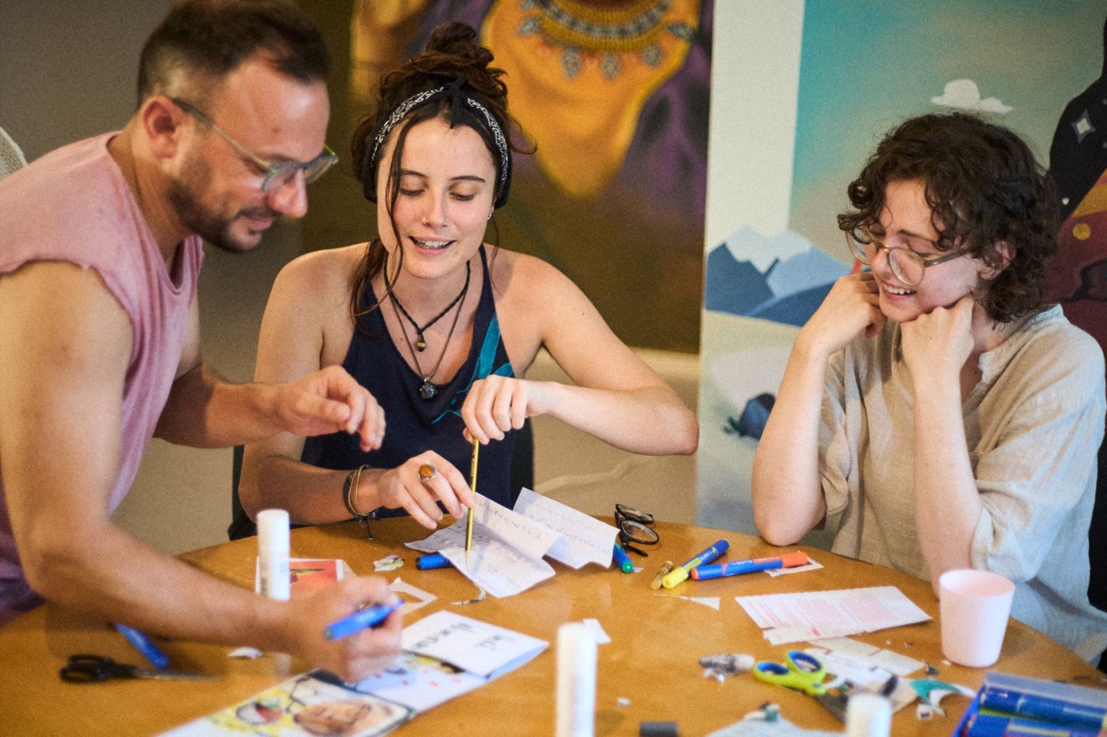 Three StartArt residents creating together around a table