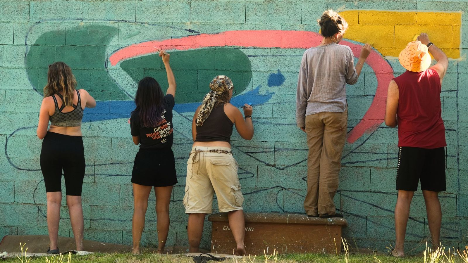 Residents painting a large mural together at StartArt